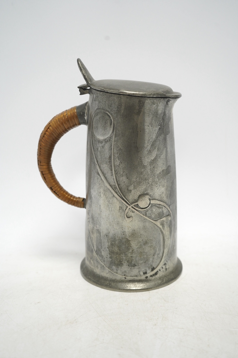 Archibald Knox, an Arts & Crafts Tudric pewter jug, with wicker handle, numbered 0305, 21cm high. Condition - good